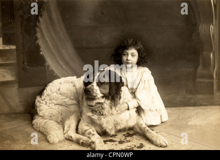 Little Girl Holding St. Bernard Dog Stock Photo