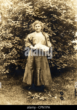 Long Haired Girl in Garden Holding White Rabbit Stock Photo