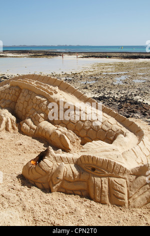 Dragon sand sculpture on Correlejo beach on Fuerteventura Stock Photo