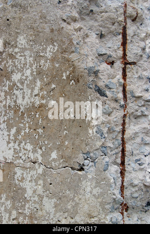 Texture of old weathered concrete wall with rusty warning stripes Stock Photo