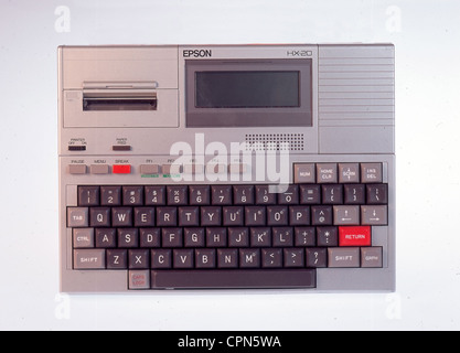 computing / electronics,computer,first laptop of the world Epson HX-20,made by Seiko Epson Corp.,with integrated LCD display,four lines with 20 letters,Made in Japan,1982,printer with 5 centimeter wide paper from the roll,16 kilobyte(maximal 32 KB)working memory,integrated accumulator,interface RS-232C,weight: 1.6 kilo,dimension DIN A4,first hand-held,original price in Germany 1982: 1798 Mark,Liquid Crystal Display,liquid crystal display,integrated dot-matrix printer,typewriter keyboard,EDP,IT,display,keyboard,keyboards,laptop,laptop,Additional-Rights-Clearences-Not Available Stock Photo
