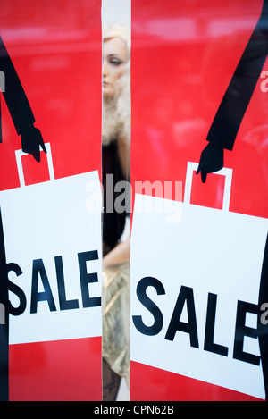 Sale signs in shop window Stock Photo