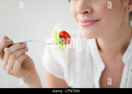 Woman eating salad, cropped Stock Photo