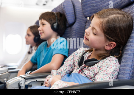 Girl sleeping on airplane Stock Photo