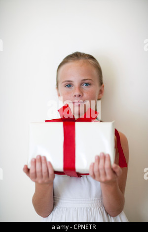 Girl holding wrapped gift Stock Photo