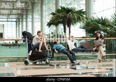Family waiting in airport terminal Stock Photo