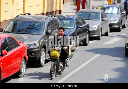 A man in a bike in Shanghai. Stock Photo