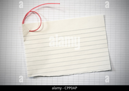 torn lined paper with red wire in shape of number six over data paper sheet, vignetted horizontal shot Stock Photo
