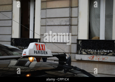 Taxi sign on an occupied cab in Paris, France