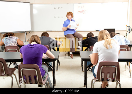 Teacher at the head of the class, teaching algebra to high school students.  Stock Photo