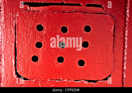 Red ventilating lattice with round holes Stock Photo