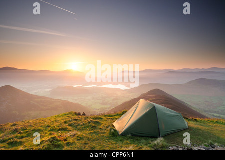 Wild camping at sunrise on Causey Pike in English Lake District. Derwent Water Skiddaw Blencathra and Cat Bells in background Stock Photo