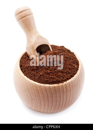 ground coffee in a wooden bowl with scoop on white Stock Photo