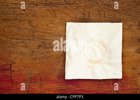 napkin with coffee stains on a grunge scratched wooden table Stock Photo