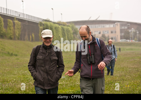 Two men talk and walk along the river bank of the River Wear, during a wildlife and birding walk. Stock Photo