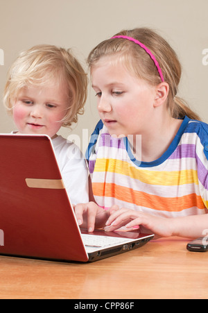 Happy adolescent boy using computer with couple parents Stock Photo - Alamy