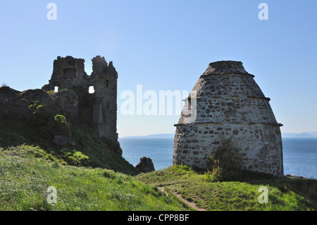 This is the remains of 13th century Dunure Castle. To the front and right is a dovecote in which they stored food. Stock Photo