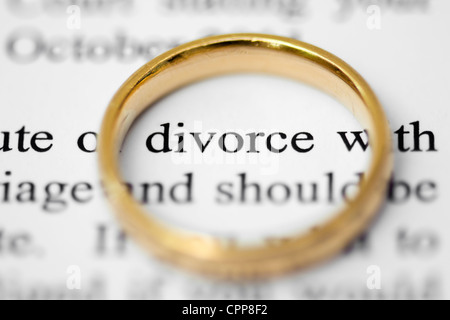 Wedding ring on top of solicitors letter highlighting the words divorce, concept of separation and divorce Stock Photo