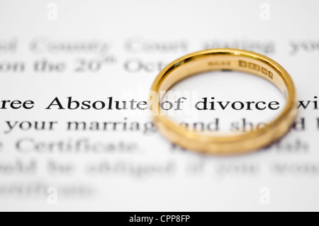 Wedding ring on top of solicitors letter highlighting the words absolute of divorce, concept of separation and divorce Stock Photo