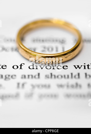 Wedding ring on top of solicitors letter highlighting the words divorce, concept of separation and divorce Stock Photo