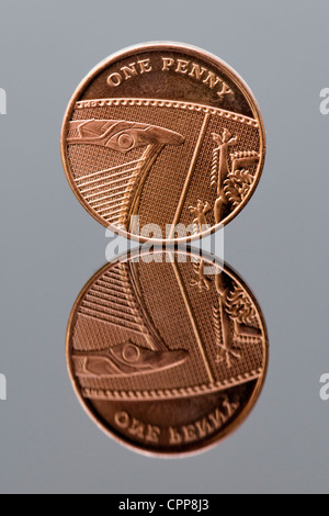 One new penny piece with reflection, concept every penny counts Stock Photo