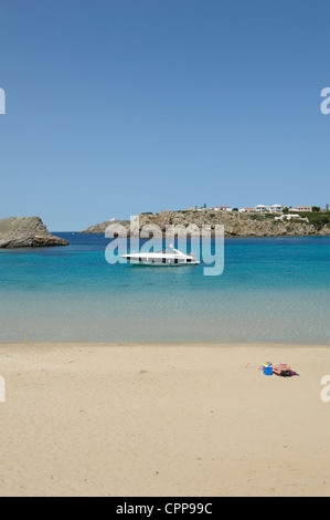 lone sunbather on the beach arenal d'en castell menorca spain Stock Photo