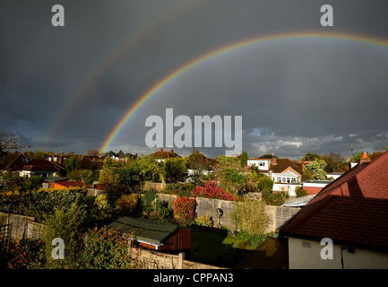 Double rainbow over British suburban rooftops Stock Photo
