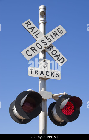 3 tracks railroad crossing sign with blinking red lights Stock Photo