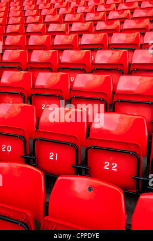 Red seats in the Kop at Anfield, home of Liverpool Football Club, when stadium is empty. Stock Photo