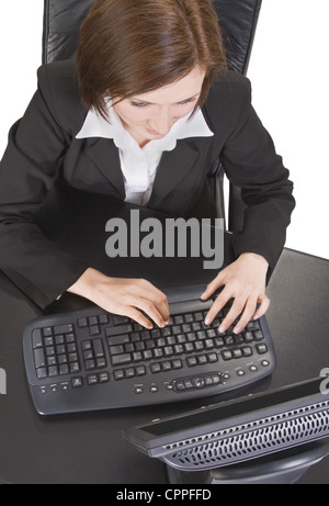 Upper view of a young businesswoman working on a computer. Stock Photo