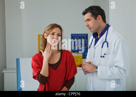 WOMAN PALPATING LYMPH NODE Stock Photo