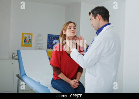 WOMAN PALPATING LYMPH NODE Stock Photo