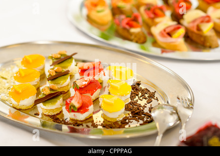 Appetizers mini desserts on catering buffet white tablecloth Stock Photo