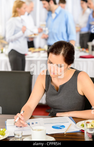 Business woman at company conference work during buffet lunch Stock Photo