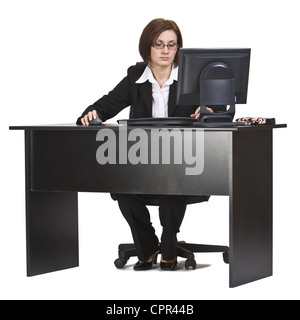 Businesswoman working on a computer at her office desk isolated against a white background. Stock Photo