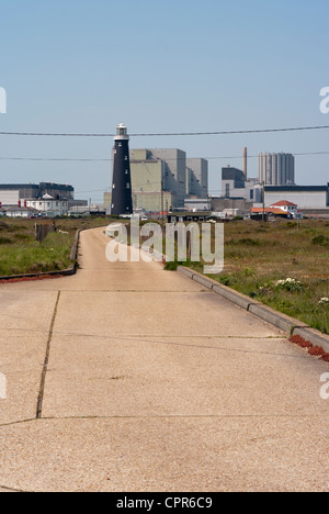 Dungeness Nuclear Power Station Kent Uk with The Old Lighthouse In The Foreground Seen Through Summer Heat Haze Stock Photo