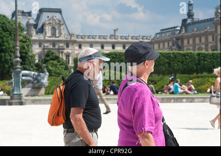 Paris, France - An elderly couple of tourists  walking in the streets. Stock Photo