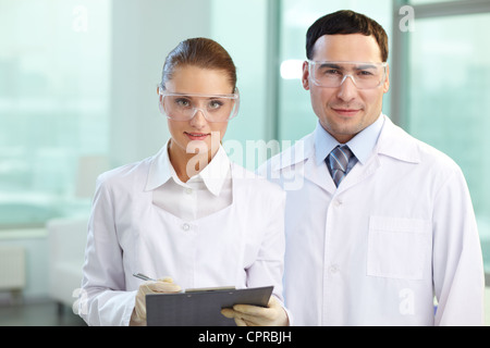 Portrait of two scientists looking at camera and smiling Stock Photo