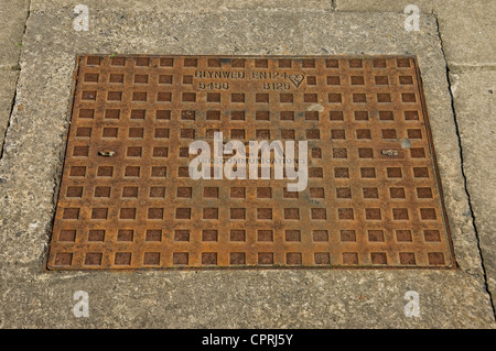 Close up of inspection manhole cover for BCM telephone telecoms cables set in pavement England UK United Kingdom GB Great Britain Stock Photo