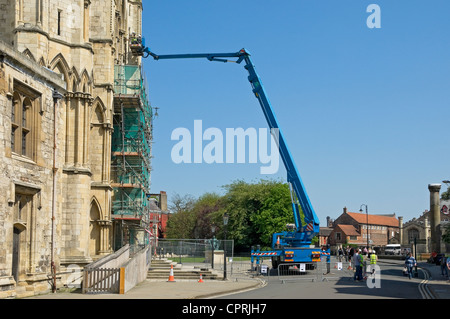 Worker Workers on crane inspecting stonework on the South Transept of York Minster North Yorkshire England UK United Kingdom GB Great Britain Stock Photo