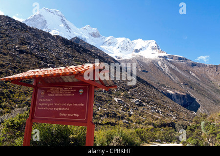 Huandoy mountain, in the Cordillera Blanca, Peru, as seen from the Laguna Paron side, with Huascaran national park welcome sign Stock Photo
