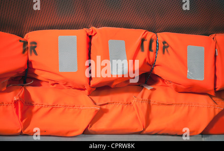 Orange life-jackets bright background Stock Photo