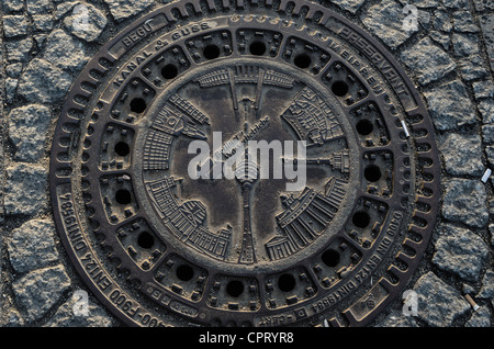 Manhole cover with touristic symbols Stock Photo