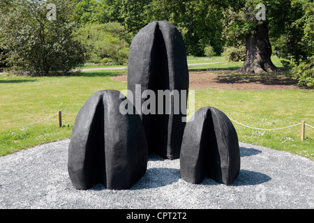 The 'Three Humps' sculpture by David Nash, part of David Nash at Kew Gardens, Royal Botanic Gardens, Kew, Surrey. May 2012 Stock Photo