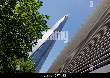 Top of the Shard skyscraper aka the London Bridge Tower and glass windows of office buildings, London, England Stock Photo