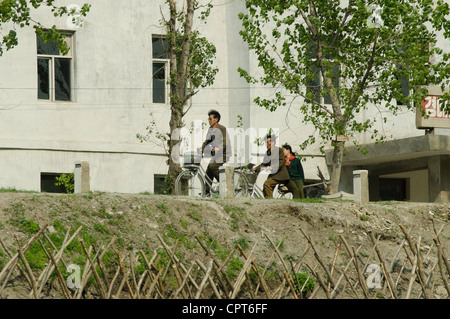 JI'AN, JILIN, CHINA; 20/05/2012. A North Korean is seen driving his cycle along the banks of the Yalu River. Stock Photo