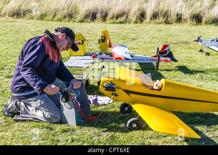 Man preparing Radio Control RC airplane for flight