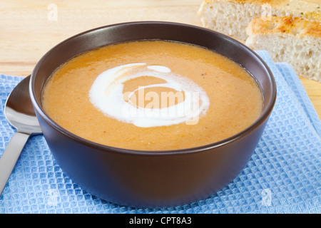 A bowl of homely lentil and carrot soup, swirled with yoghurt. Stock Photo