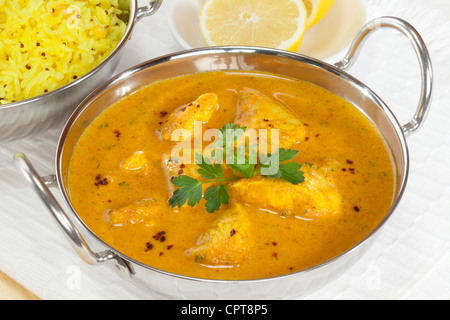 A balti dish with a Peshwari style chicken curry, with basmati rice and lemon in the background. Stock Photo