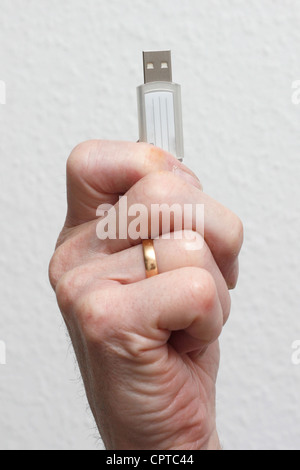 Senior holding a USB drive Stock Photo